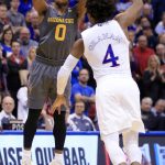 Arizona State guard Tra Holder (0) shoots over Kansas guard Devonte' Graham (4) during the second half of an NCAA college basketball game in Lawrence, Kan., Sunday, Dec. 10, 2017. Holder scored 29 points in the game. Arizona State defeated Kansas 95-85. (AP Photo/Orlin Wagner)