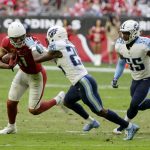 Arizona Cardinals wide receiver Larry Fitzgerald, left, runs with the football after making a catch as Tennessee Titans cornerback Adoree' Jackson (25) tries to make the tackle and Titans linebacker Jayon Brown (55) closes in during the second half of an NFL football game, Sunday, Dec. 10, 2017, in Glendale, Ariz. (AP Photo/Rick Scuteri)