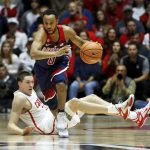 Arizona's Parker Jackson-Cartwright head up courts as New Mexico's Joe Furstinger falls in the second half of an NCAA college basketball game, Saturday, Dec. 16, 2017, in Albuquerque, N.M. Arizona won, 89-73. (AP Photo/Eric Draper)