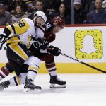 Pittsburgh Penguins defenseman Kris Letang (58) and Max Domi (16) battle for the puck in the second period during an NHL hockey game, Saturday, Dec 16, 2017, in Glendale, Ariz. (AP Photo/Rick Scuteri)