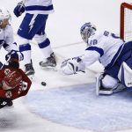 Tampa Bay Lightning goalie Andrei Vasilevskiy (88) makes a diving save on a shot as Arizona Coyotes center Clayton Keller (9) is checked to the ice by Lightning defenseman Dan Girardi (5) during the first period of an NHL hockey game, Thursday, Dec. 14, 2017, in Glendale, Ariz. (AP Photo/Ross Franklin)