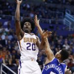Phoenix Suns forward Josh Jackson (20) shoots over Philadelphia 76ers guard Timothe Luwawu-Cabarrot (7) during the second half of an NBA basketball game Sunday, Dec. 31, 2017, in Phoenix. The 76ers defeated the Suns 123-110. (AP Photo/Ross D. Franklin)