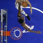 Phoenix Suns' Devin Booker, top, goes up for a shot against Philadelphia 76ers' Joel Embiid during the first half of an NBA basketball game, Monday, Dec. 4, 2017, in Philadelphia. Devin Booker 115-101. (AP Photo/Matt Slocum)