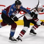 Colorado Avalanche defenseman Nikita Zadorov, left, of Russia, reaches out to slow Arizona Coyotes center Clayton Keller as they pursued the puck during the third period of an NHL hockey game Wednesday, Dec. 27, 2017, in Denver. The Coyotes won 3-1. (AP Photo/David Zalubowski)
