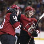 Arizona Coyotes' Dylan Strome (20) celebrates with Clayton Keller after scoring a goal against the New Jersey Devils during the third period of an NHL hockey game, Saturday, Dec. 2, 2017, in Glendale, Ariz. The goal was Strome's first career NHL goal. The Coyotes defeated the Devils 5-0. (AP Photo/Ralph Freso)