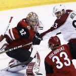 Colorado Avalanche left wing Matt Nieto (83) tries to redirect the puck as Arizona Coyotes goalie Antti Raanta (32) moves in to stop the puck while Coyotes defenseman Alex Goligoski (33) watches during the first period of an NHL hockey game, Saturday, Dec. 23, 2017, in Glendale, Ariz. (AP Photo/Ross D. Franklin)