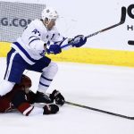 Arizona Coyotes defenseman Luke Schenn (2) tries to keep the puck away from Toronto Maple Leafs center Leo Komarov (47) during the third period of an NHL hockey game Thursday, Dec. 28, 2017, in Glendale, Ariz. The Maple Leafs defeated the Coyotes 7-4. (AP Photo/Ross D. Franklin)