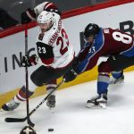 Arizona Coyotes defenseman Oliver Ekman-Larsson, left, of Sweden, is tripped while pursuing the puck Colorado Avalanche left wing Matt Nieto in the first period of an NHL hockey game Wednesday, Dec. 27, 2017, in Denver. (AP Photo/David Zalubowski)