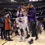 Phoenix Suns guard Devin Booker (1) is carried off by teammates during the second half of an NBA basketball game against the Toronto Raptors on Tuesday, Dec. 5, 2017, in Toronto. (Nathan Denette/The Canadian Press via AP)