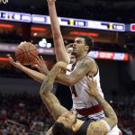 Grand Canyon forward Keonta Vernan (24) is knocked down as Louisville guard Quentin Snider (4) drives to the basket during the second half of an NCAA college basketball game, Saturday, Dec. 23, 2017, in Louisville, Ky. Behind Snider is Grand Canyon forward Alessandro Lever (25). Louisville won 74-56. (AP Photo/Timothy D. Easley)