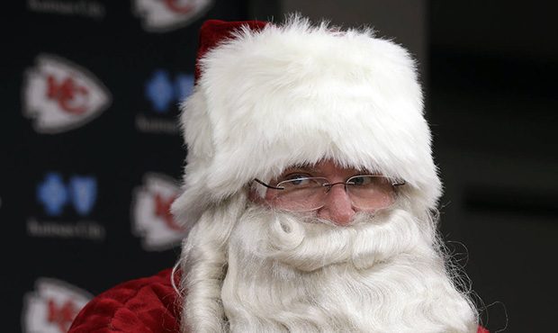 Kansas City Chiefs head coach Andy Reid wears a Santa Claus costume during a news conference follow...