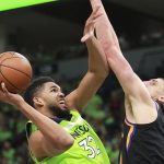 Minnesota Timberwolves forward Karl-Anthony Towns (32) is fouled by Phoenix Suns center Alex Len (21) in the fourth quarter of an NBA basketball game on Saturday, Dec. 16, 2017, in Minneapolis. (AP Photo/Andy Clayton-King)