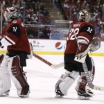 Having given up three goals to the Colorado Avalanche, Arizona Coyotes goalie Antti Raanta (32) is replaced by Scott Wedgewood (31) during the second period of an NHL hockey game Saturday, Dec. 23, 2017, in Glendale, Ariz. (AP Photo/Ross D. Franklin)