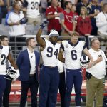 Los Angeles Rams outside linebacker Robert Quinn (94) raises his fist during the national anthem prior to an NFL football game against the Arizona Cardinals, Sunday, Dec. 3, 2017, in Glendale, Ariz. (AP Photo/Ross D. Franklin)
