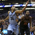 Memphis Grizzlies center Brandan Wright (34) reaches for the ball in front of Phoenix Suns' Greg Monroe (14) ball during the second half of an NBA basketball game Thursday, Dec. 21, 2017, in Phoenix. (AP Photo/Ralph Freso)