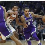Sacramento Kings guard George Hill (3) drives to the basket around Phoenix Suns forward TJ Warren (12) during the first half of an NBA basketball game in Sacramento, Calif., Friday, Dec. 29, 2017. (AP Photo/Steve Yeater)