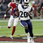 Los Angeles Rams free safety Lamarcus Joyner (20) runs after an interception as Arizona Cardinals wide receiver J.J. Nelson pursues during the first half of an NFL football game, Sunday, Dec. 3, 2017, in Glendale, Ariz. (AP Photo/Rick Scuteri)