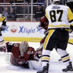 Arizona Coyotes goalie Antti Raanta (32) makes the save in front of Pittsburgh Penguins center Sidney Crosby in the third period during an NHL hockey game, Saturday, Dec 16, 2017, in Glendale, Ariz. Pittsburgh defeated Arizona 4-2. (AP Photo/Rick Scuteri)