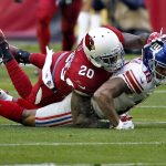 Arizona Cardinals inside linebacker Deone Bucannon (20) forces New York Giants wide receiver Roger Lewis (18) to fumble during the first half of an NFL football game, Sunday, Dec. 24, 2017, in Glendale, Ariz. The Cardinals recovered the football. (AP Photo/Ross D. Franklin)