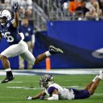 Penn State running back Saquon Barkley (26) leaps over Washington defensive back Myles Bryant (5) during the second half of the Fiesta Bowl NCAA college football game Saturday, Dec. 30, 2017, in Glendale, Ariz. (AP Photo/Ross D. Franklin)