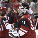 Arizona Coyotes goalie Scott Wedgewood (31) is congratulated by Kevin Connauton (44) after a 5-0 shutout victory against the New Jersey Devils during an NHL hockey game, Saturday, Dec. 2, 2017, in Glendale, Ariz. (AP Photo/Ralph Freso)