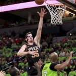Phoenix Suns center Dragan Bender (35) shoots over Minnesota Timberwolves center Taj Gibson (67) in the first quarter of an NBA basketball game on Saturday, Dec. 16, 2017, in Minneapolis. (AP Photo/Andy Clayton-King)