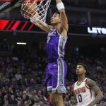 Sacramento Kings forward Skal Labissiere (7) gets past Phoenix Suns forward Marquese Chriss (0) for a dunk during the first half of an NBA basketball game in Sacramento, Calif., Friday, Dec. 29, 2017. (AP Photo/Steve Yeater)