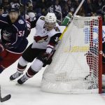 Columbus Blue Jackets' Sergei Bobrovsky, right, of Russia, protects the goal as teammate David Savard, left, tries to clear the puck past Arizona Coyotes' Christian Fischer during the third period of an NHL hockey game Saturday, Dec. 9, 2017, in Columbus, Ohio. (AP Photo/Jay LaPrete)