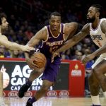 Phoenix Suns forward TJ Warren, middle, drives to the basket between Los Angeles Clippers guard Milos Teodosic, left, and center DeAndre Jordan during the first half of an NBA basketball game in Los Angeles, Wednesday, Dec. 20, 2017. (AP Photo/Chris Carlson)