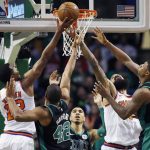 Phoenix Suns' TJ Warren (12) and Tyson Chandler, second from right, try to tip in the rebound against Boston Celtics' Al Horford (42) and Marcus Smart (36) during the fourth quarter of an NBA basketball game in Boston, Saturday, Dec. 2, 2017. The Celtics won 116-111. (AP Photo/Michael Dwyer)