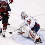 Washington Capitals goalie Philipp Grubauer (31) makes a save on a redirect from Arizona Coyotes left wing Jordan Martinook (48) during the first period of an NHL hockey game, Friday, Dec. 22, 2017, in Glendale, Ariz. (AP Photo/Ross D. Franklin)