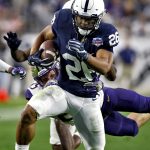 Penn State running back Saquon Barkley (26) carries as Washington linebacker Ben Burr-Kirven reaches for a tackle during the second half of the Fiesta Bowl NCAA college football game Saturday, Dec. 30, 2017, in Glendale, Ariz. (AP Photo/Ross D. Franklin)