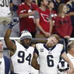 Los Angeles Rams outside linebacker Robert Quinn (94) raises his fist during the national anthem prior to an NFL football game against the Arizona Cardinals, Sunday, Dec. 3, 2017, in Glendale, Ariz. (AP Photo/Ross D. Franklin)