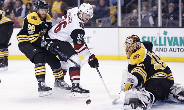 Boston Bruins' Tuukka Rask (40), of Finland, deflects a shot by Arizona Coyotes' Christian Fischer ...