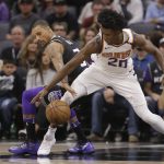 Sacramento Kings guard George Hill, left, and Phoenix Suns forward Josh Jackson go for the ball during the first quarter of an NBA basketball game Tuesday, Dec. 12, 2017, in Sacramento, Calif. (AP Photo/Rich Pedroncelli)