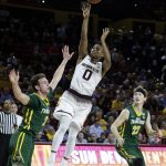 Arizona State guard Tra Holder (0) shoots between San Francisco guard Frankie Ferrari and Chase Foster (22) in the second half during an NCAA college basketball game, Saturday, Dec 2, 2017, in Tempe, Ariz. Arizona State defeated San Francisco 75-57. (AP Photo/Rick Scuteri)