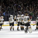 The Vegas Golden Knights salute the crowd after defeating the Arizona Coyotes 3-2 in overtime after an NHL hockey game, Sunday, Dec. 3, 2017, in Las Vegas. (AP Photo/David Becker)