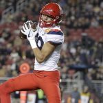 Arizona wide receiver Shawn Poindexter makes a touchdown reception against Purdue during the first half of the Foster Farms Bowl NCAA college football game Wednesday, Dec. 27, 2017, in Santa Clara, Calif. (AP Photo/Marcio Jose Sanchez)