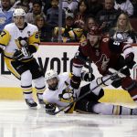 Pittsburgh Penguins defenseman Kris Letang (58) and Sidney Crosby (87) battle for the puck with Arizona Coyotes defenseman Jason Demers (55) in the second period during an NHL hockey game, Saturday, Dec 16, 2017, in Glendale, Ariz. (AP Photo/Rick Scuteri)