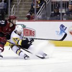 Pittsburgh Penguins right wing Bryan Rust (17) shields Arizona Coyotes defenseman Oliver Ekman-Larsson from the puck in the third period during an NHL hockey game, Saturday, Dec 16, 2017, in Glendale, Ariz. Pittsburgh defeated Arizona 4-2. (AP Photo/Rick Scuteri)