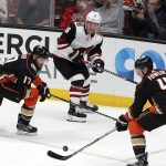 Arizona Coyotes left winger Max Domi (16) and Anaheim Ducks center Ryan Kesler (17) and defenseman Cam Fowler (4) battle in the second period of an NHL hockey game in Anaheim, Calif., Sunday, Dec. 31, 2017. (AP Photo/Reed Saxon)