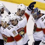 Florida Panthers goalie James Reimer (34) celebrates a win against the Arizona Coyotes with Panthers defenseman Aaron Ekblad (5), right wing Evgenii Dadonov (63), center Denis Malgin (62), and right wing Radim Vrbata (71) after an NHL hockey game, Tuesday, Dec. 19, 2017, in Glendale, Ariz. The Panthers defeated the Coyotes 3-2. (AP Photo/Ross D. Franklin)