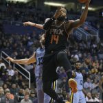 Phoenix Suns center Greg Monroe (14) drives to the basket past Memphis Grizzlies' Marc Gasol (33) during the first half of an NBA basketball game Thursday, Dec. 21, 2017, in Phoenix. (AP Photo/Ralph Freso)