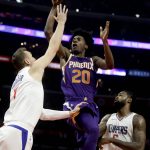 Phoenix Suns forward Josh Jackson, middle, shoots between Los Angeles Clippers forward Sam Dekker, left, and center DeAndre Jordan during the first half of an NBA basketball game in Los Angeles, Wednesday, Dec. 20, 2017. (AP Photo/Chris Carlson)