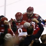 Arizona Coyotes center Clayton Keller, middle, celebrates his overtime against the Washington Capitals with defenseman Alex Goligoski (33) in an NHL hockey game, Friday, Dec. 22, 2017, in Glendale, Ariz. The Coyotes defeated the Capitals 3-2. (AP Photo/Ross D. Franklin)