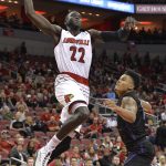 Louisville forward Deng Adel (22) goes in for a dunk past the defense of Grand Canyon guard Damari Milstead (10) during the second half of an NCAA college basketball game, Saturday, Dec. 23, 2017, in Louisville, Ky. Louisville won 74-56. (AP Photo/Timothy D. Easley)