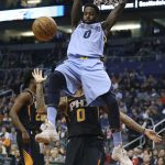 Memphis Grizzlies JaMychal Green, top, dunks the ball over Phoenix Suns' Marquese Chriss (0) during the first half of an NBA basketball game Thursday, Dec. 21, 2017, in Phoenix. (AP Photo/Ralph Freso)