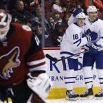 Toronto Maple Leafs center Patrick Marleau (12) celebrates his goal against Arizona Coyotes goalie Scott Wedgewood, left, with Maple Leafs center Mitchell Marner (16) during the second period of an NHL hockey game Thursday, Dec. 28, 2017, in Glendale, Ariz. (AP Photo/Ross D. Franklin)