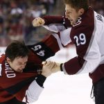 Colorado Avalanche center Nathan MacKinnon (29) tries to land a punch on Arizona Coyotes right wing Josh Archibald (45) as the two fight during the second period of an NHL hockey game Saturday, Dec. 23, 2017, in Glendale, Ariz. (AP Photo/Ross D. Franklin)