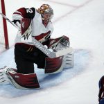 Arizona Coyotes goalie Antti Raanta, left, of Finland, deflects as hot by Colorado Avalanche center Tyson Jost during the third period of an NHL hockey game Wednesday, Dec. 27, 2017, in Denver. The Coyotes won 3-1. (AP Photo/David Zalubowski)